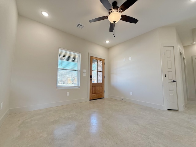 interior space with baseboards, visible vents, a ceiling fan, concrete floors, and recessed lighting