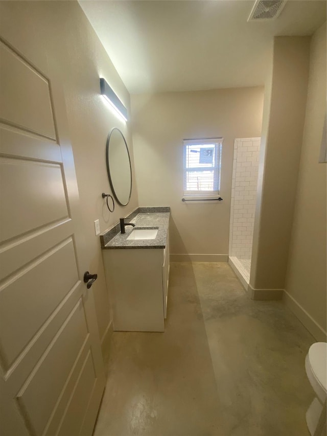 bathroom with vanity, toilet, concrete floors, and a shower