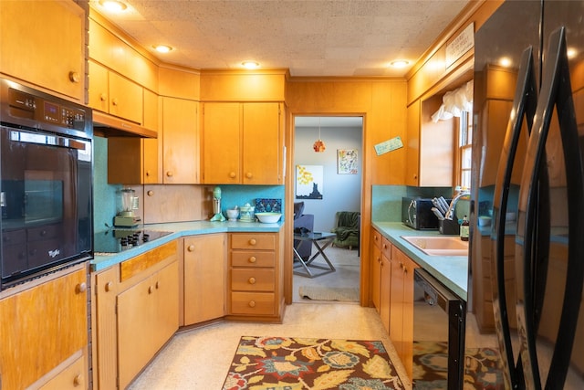 kitchen featuring backsplash, ornamental molding, sink, and black appliances