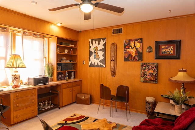 office space with crown molding, light colored carpet, and wood walls