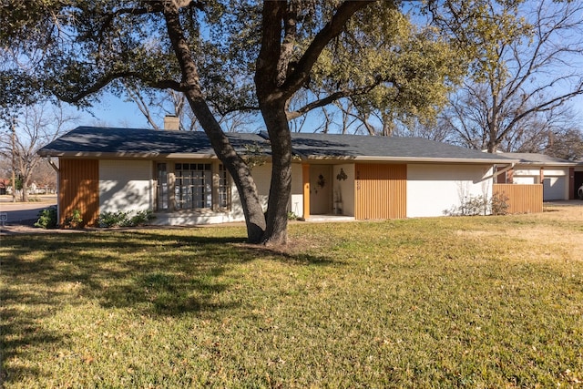 rear view of property with a yard