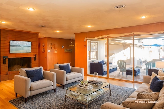 living room with wood-type flooring and wood walls