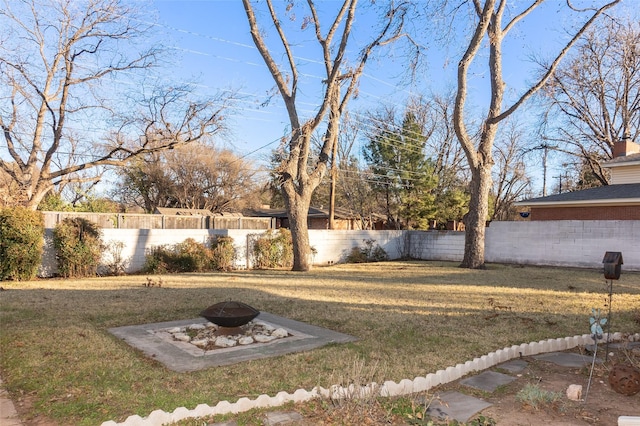 view of yard with an outdoor fire pit