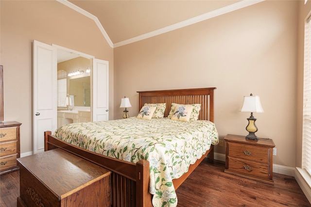 bedroom with ornamental molding, lofted ceiling, dark wood finished floors, baseboards, and ensuite bath