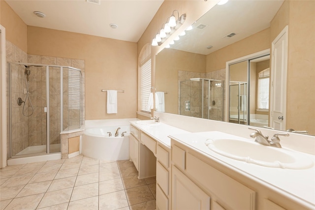 bathroom featuring independent shower and bath, vanity, and tile patterned floors