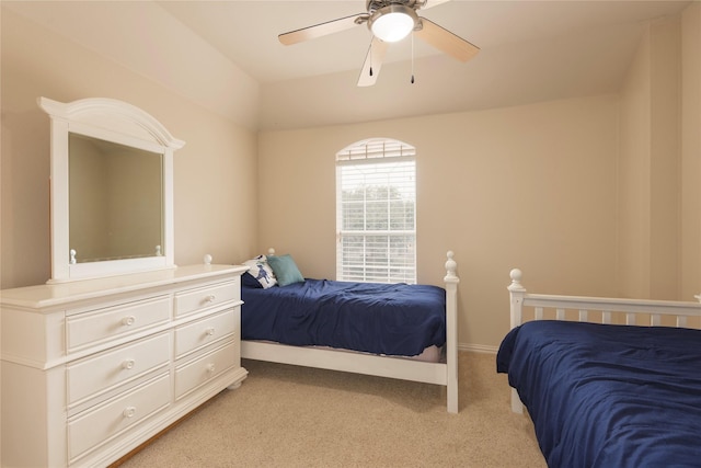 bedroom with ceiling fan, baseboards, and light colored carpet