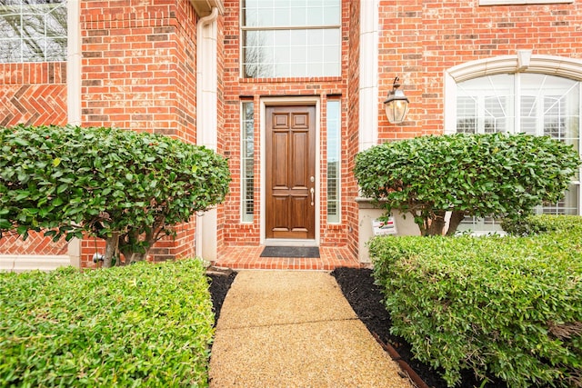 property entrance featuring brick siding