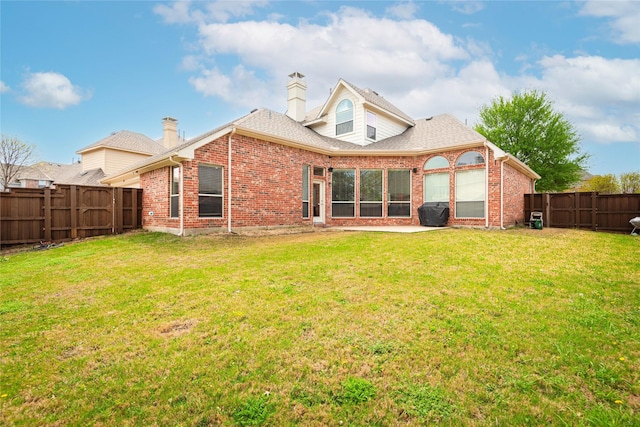 1404 Rio Grande Dr, Allen, TX 75013 - rear view of house with a fenced backyard, a chimney, brick siding, and roof with shingles