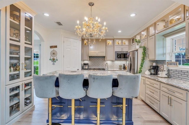 kitchen featuring built in microwave, stainless steel refrigerator, and a kitchen island