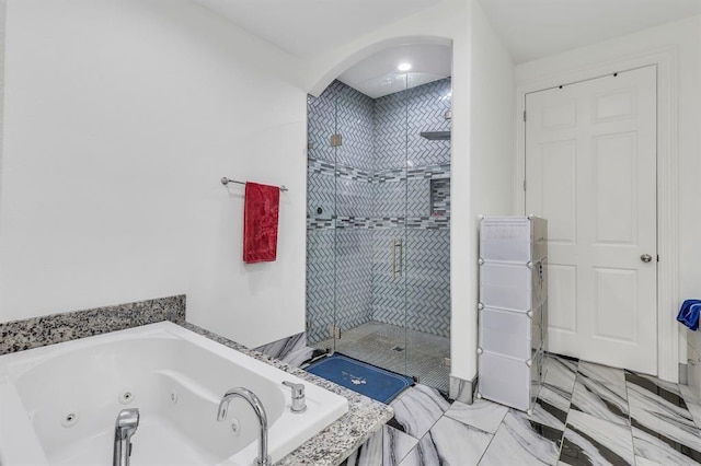 bathroom featuring separate shower and tub