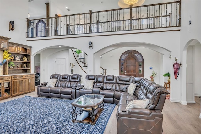 living room featuring hardwood / wood-style flooring and a high ceiling