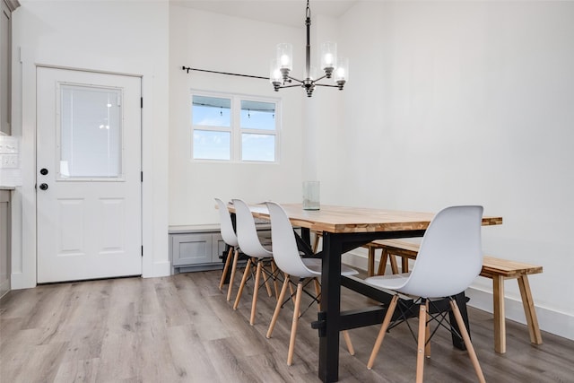 dining room with an inviting chandelier and light hardwood / wood-style flooring