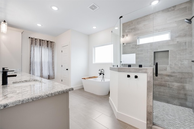 bathroom with shower with separate bathtub and vanity