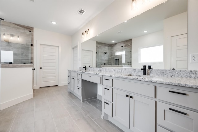 bathroom with vanity and a shower with shower door