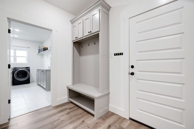 mudroom with washer / clothes dryer and light hardwood / wood-style flooring