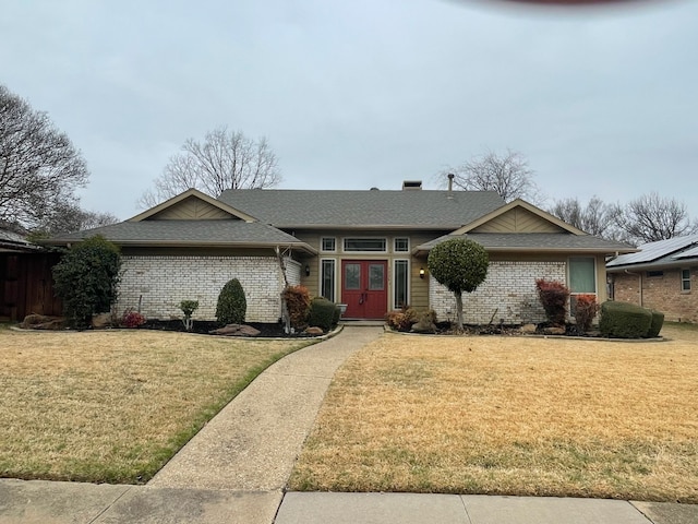 single story home with a front lawn and french doors