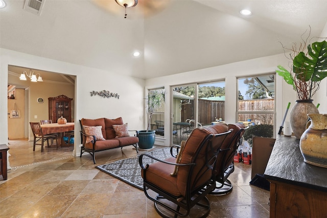 living room featuring an inviting chandelier and vaulted ceiling