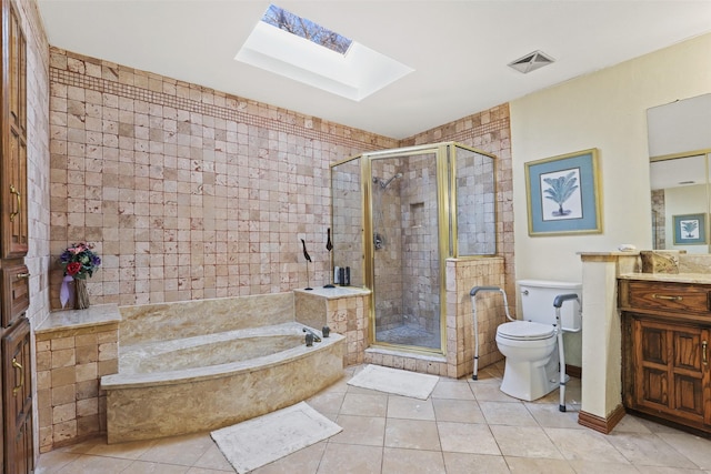 full bathroom with a skylight, independent shower and bath, tile patterned flooring, vanity, and toilet