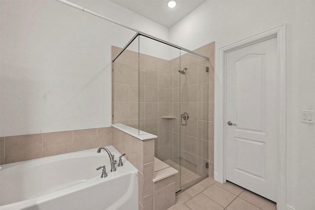 bathroom featuring tile patterned floors and independent shower and bath