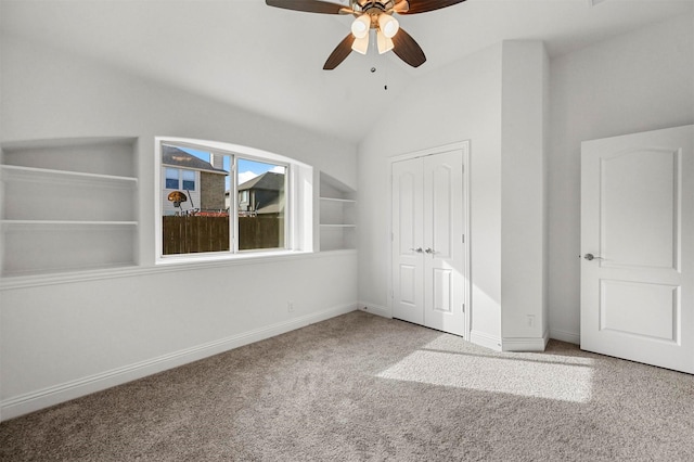 unfurnished bedroom with lofted ceiling, a closet, ceiling fan, and carpet