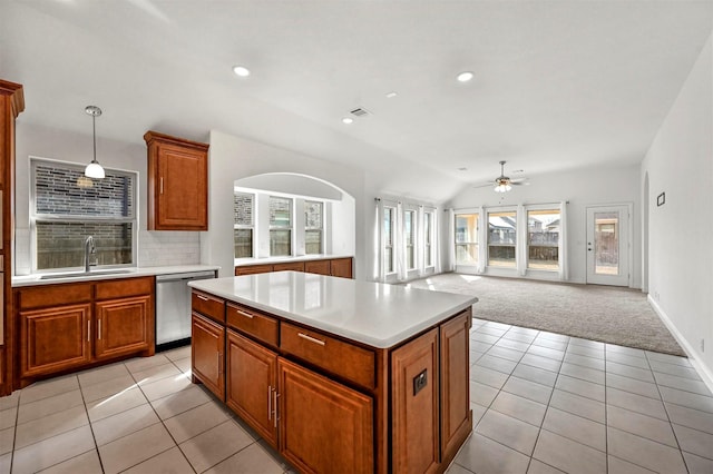 kitchen featuring sink, a center island, hanging light fixtures, light tile patterned floors, and dishwasher