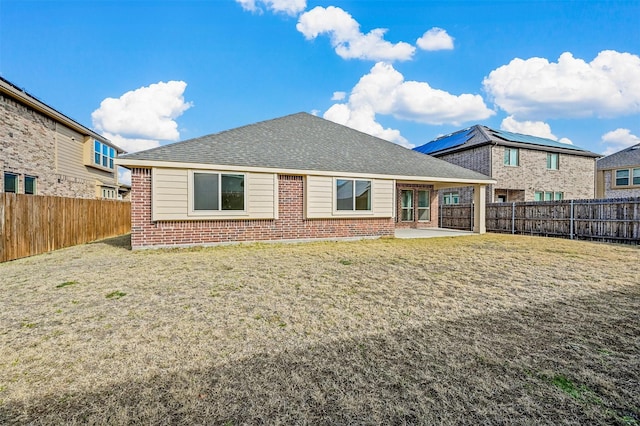 rear view of property featuring a patio and a yard