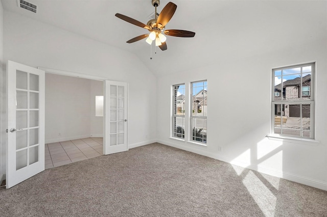 unfurnished room with vaulted ceiling, light colored carpet, french doors, and ceiling fan