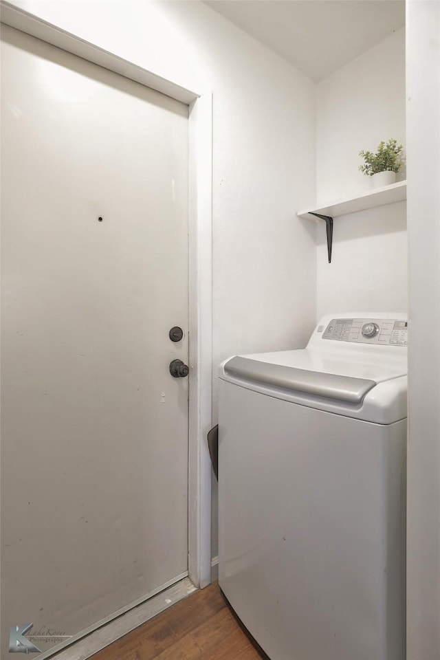 clothes washing area with dark hardwood / wood-style flooring and washer / clothes dryer