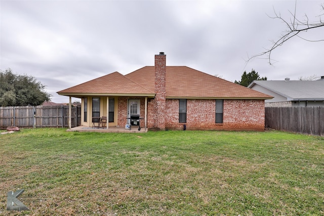 back of property featuring a yard and a patio