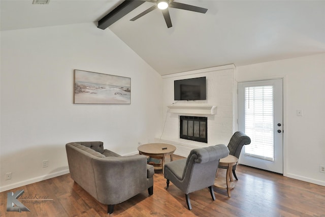 living room featuring dark hardwood / wood-style flooring, lofted ceiling with beams, and ceiling fan