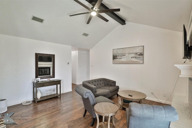 living room featuring dark wood-type flooring, ceiling fan, and vaulted ceiling with beams