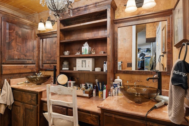 bathroom featuring built in features, wooden ceiling, a notable chandelier, and vanity