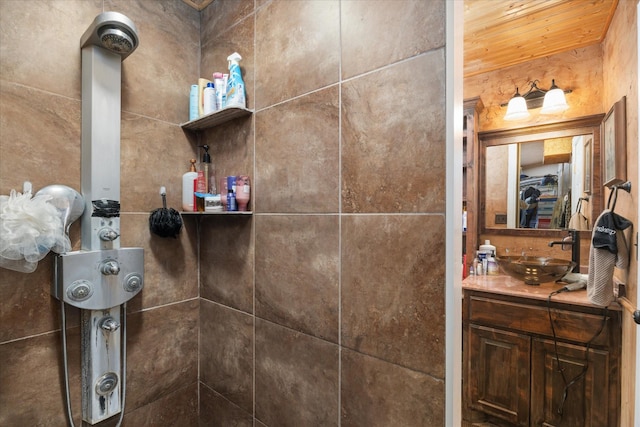 interior details with a tile shower and vanity