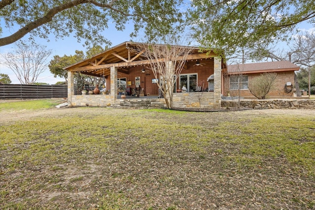 back of property featuring ceiling fan, a patio, a yard, and fence