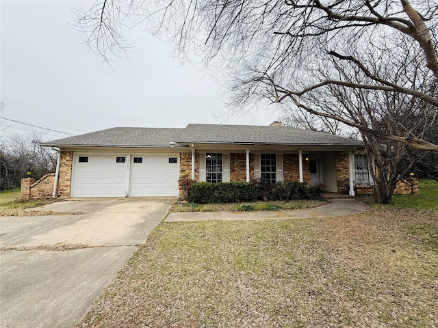 ranch-style home featuring a front lawn, roof with shingles, driveway, and an attached garage