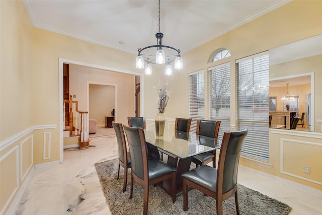 dining space featuring a notable chandelier and crown molding