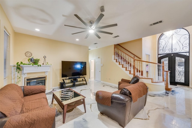 living room with ceiling fan and french doors