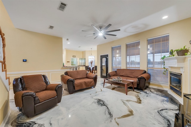 living room featuring a wealth of natural light and ceiling fan