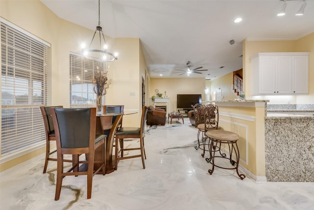 dining area featuring ceiling fan with notable chandelier