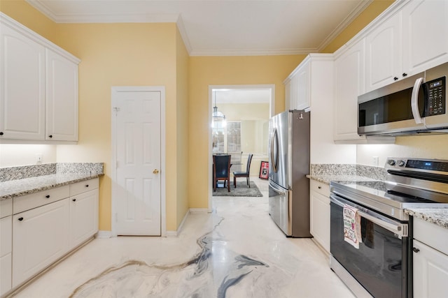 kitchen featuring light stone counters, ornamental molding, stainless steel appliances, and white cabinets