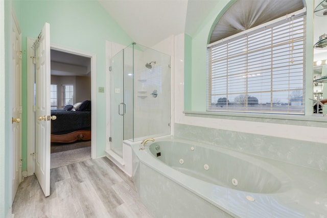 bathroom with lofted ceiling, wood-type flooring, and independent shower and bath