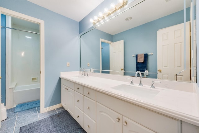 bathroom featuring tile patterned flooring, vanity, and bathing tub / shower combination