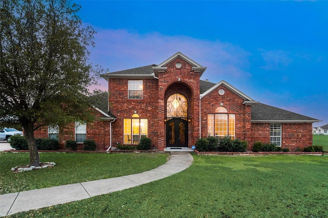 front of property featuring a yard and french doors