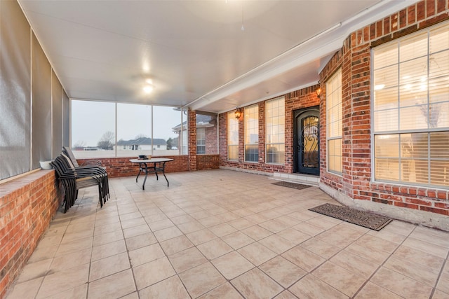 sunroom / solarium with a fireplace