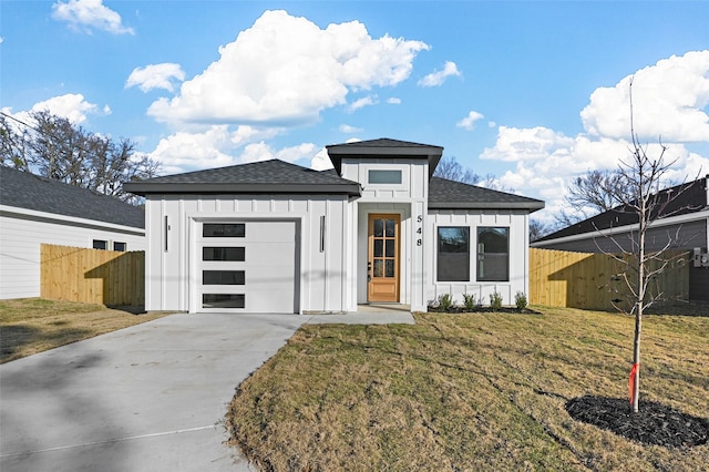 prairie-style home featuring a garage and a front lawn