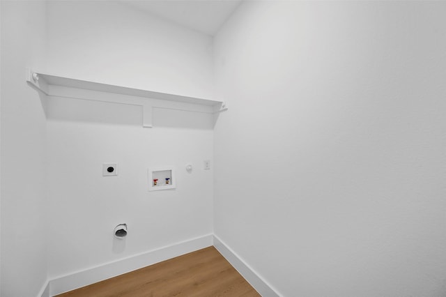 laundry room featuring hookup for a washing machine, gas dryer hookup, electric dryer hookup, and hardwood / wood-style floors