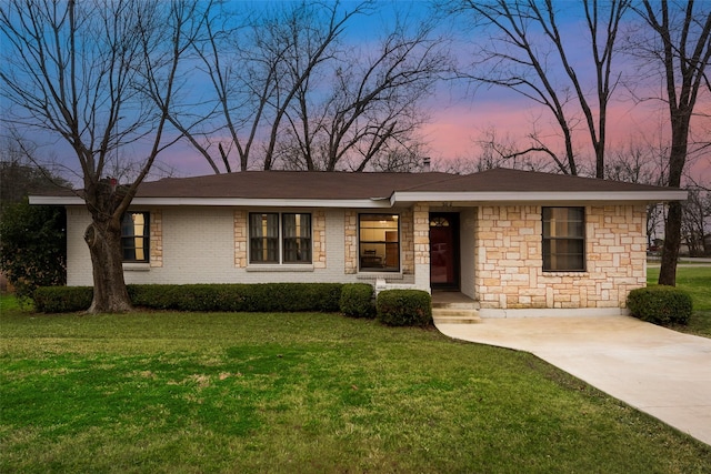 ranch-style home with a lawn