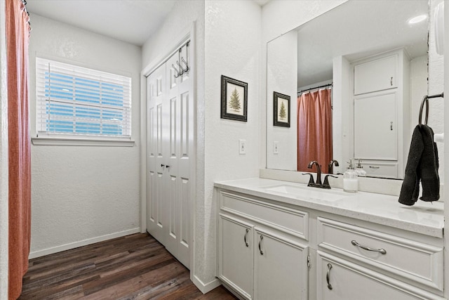 bathroom with vanity and wood-type flooring