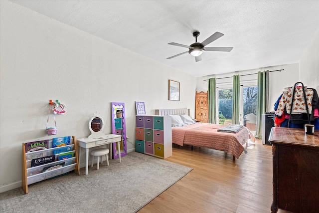 bedroom with wood-type flooring, ceiling fan, and a textured ceiling