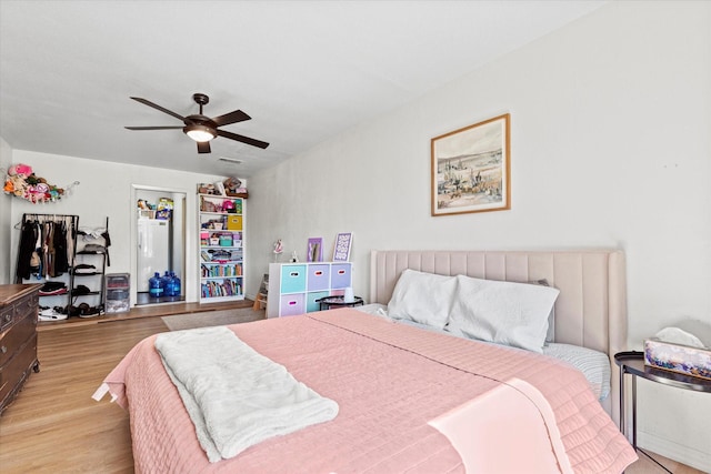 bedroom with ceiling fan and light wood-type flooring